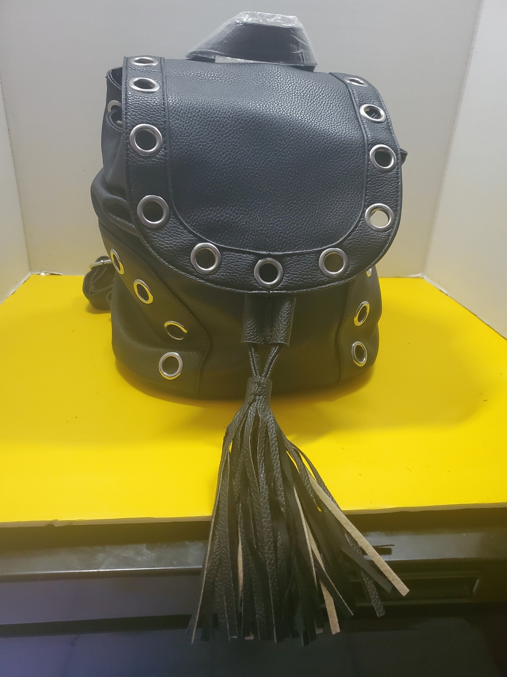 Avenue Black Faux Leather Grommet Tassel Backpack
